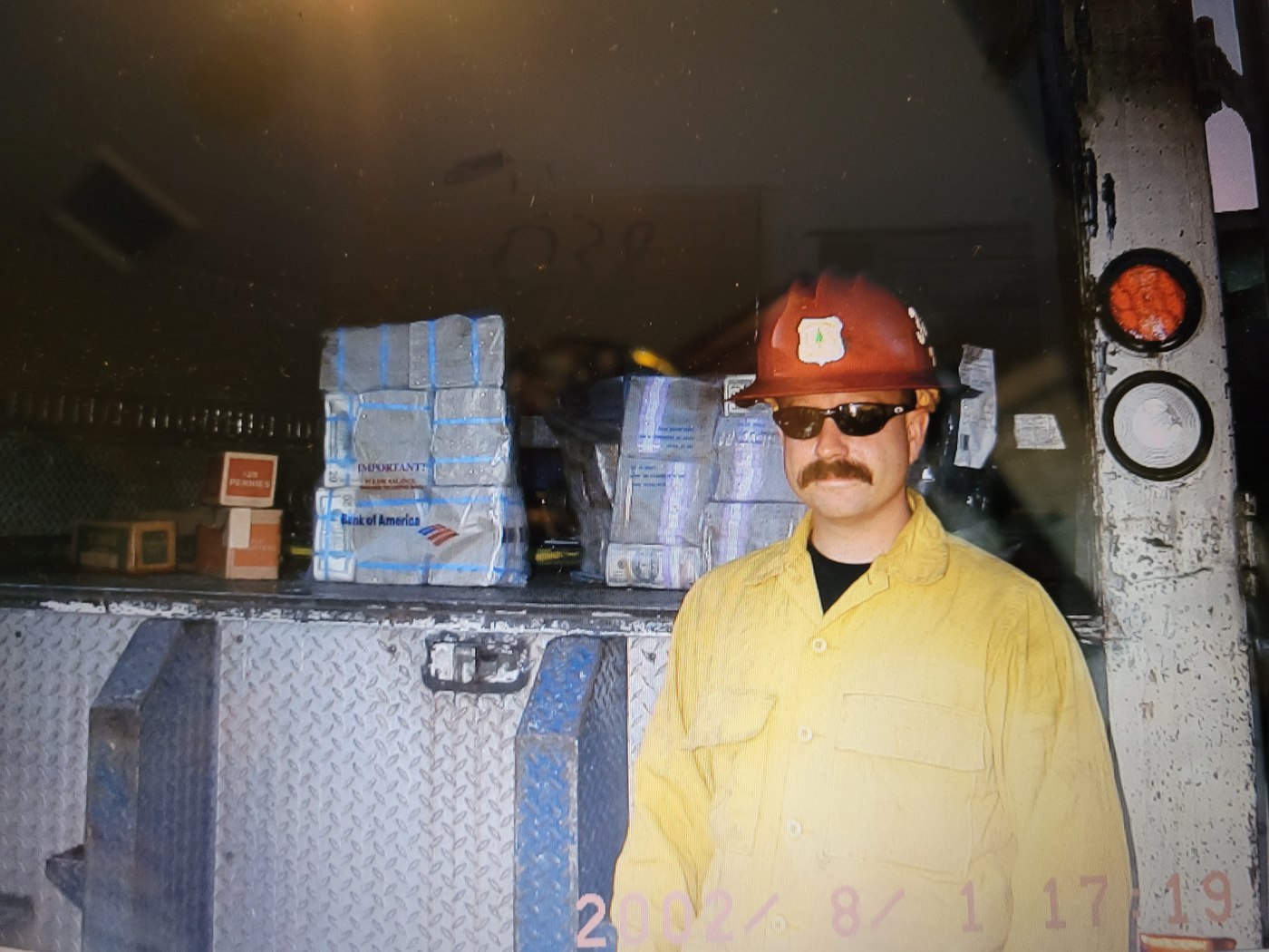Michael Karl McNeil, firefighter, in wildland gear beside an engine, 2002